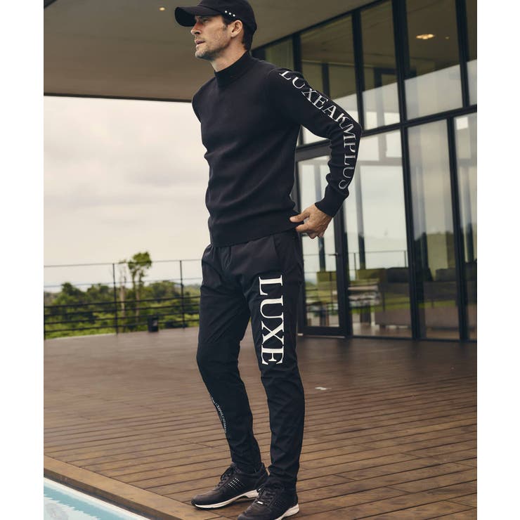 LUXEAKMPLUS リュクスエイケイエムプラス サークルロゴウィンドパンツ