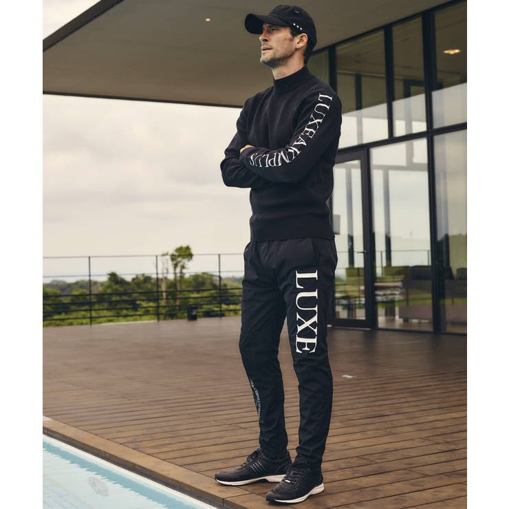 LUXEAKMPLUS リュクスエイケイエムプラス サークルロゴウィンドパンツ