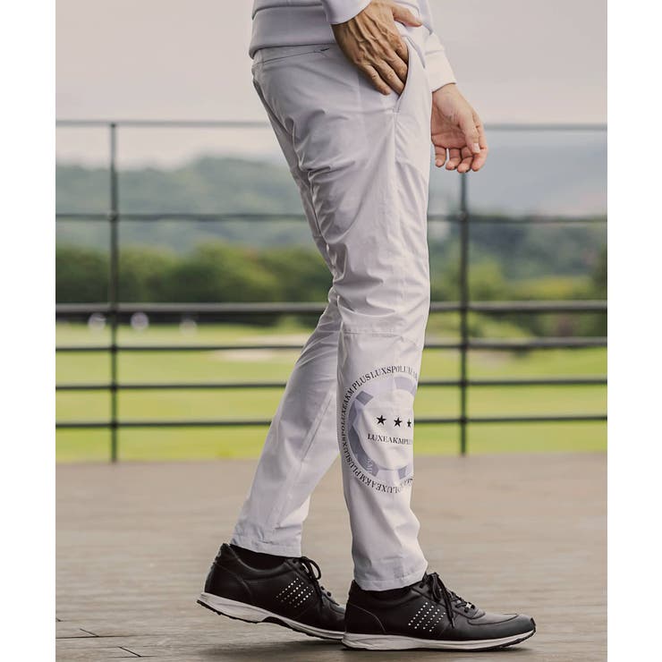 LUXEAKMPLUS リュクスエイケイエムプラス サークルロゴウィンドパンツ