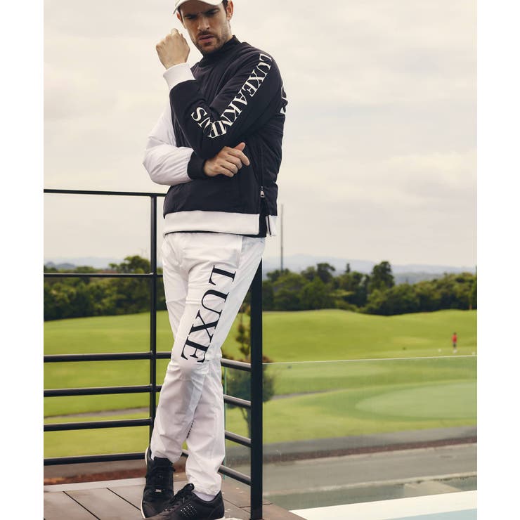 LUXEAKMPLUS リュクスエイケイエムプラス サークルロゴウィンドパンツ