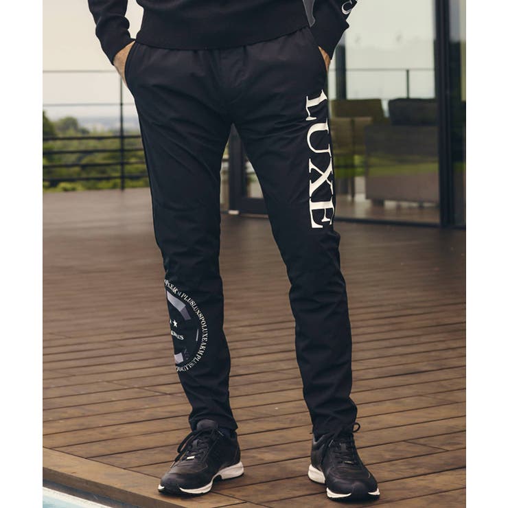 LUXEAKMPLUS リュクスエイケイエムプラス サークルロゴウィンドパンツ